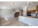 Open-concept kitchen with stainless steel sink, granite countertops, adjacent dining area, and desk at 3649 E Hazeltine Way, Chandler, AZ 85249
