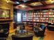 Inviting library with rich wood accents, cozy seating, and extensive bookshelves for the community to enjoy at 3649 E Hazeltine Way, Chandler, AZ 85249