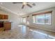 Open-concept living area with tile flooring, ceiling fan, and natural light at 3649 E Hazeltine Way, Chandler, AZ 85249