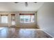 Bright living room with tile floors, a ceiling fan, and natural light from a window and sliding door at 3649 E Hazeltine Way, Chandler, AZ 85249