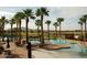 Resort-style pool surrounded by palm trees has lounge chairs and tables perfect for relaxation and entertainment at 3649 E Hazeltine Way, Chandler, AZ 85249