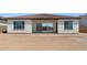 View of the home's backyard featuring stucco walls, tiled roofing, and sliding glass doors at 37727 W Padilla St, Maricopa, AZ 85138