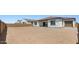 Expansive backyard with block fence, showcasing a home with garage, tiled roof, and stucco at 37727 W Padilla St, Maricopa, AZ 85138