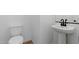 Bathroom featuring a pedestal sink and toilet at 37727 W Padilla St, Maricopa, AZ 85138