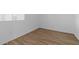 Empty bedroom featuring tile flooring and natural light from the window at 37727 W Padilla St, Maricopa, AZ 85138