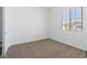 Cozy bedroom featuring carpet flooring and a bright window at 37727 W Padilla St, Maricopa, AZ 85138