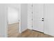 Bright entryway with a white door and light wood-look flooring, seamlessly connecting to other spaces at 37727 W Padilla St, Maricopa, AZ 85138