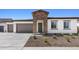 Charming single-story home featuring stone accents, a two-car garage, and desert landscaping at 37727 W Padilla St, Maricopa, AZ 85138