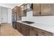 Gourmet kitchen featuring stainless steel appliances, modern cabinets, and sleek countertops at 37727 W Padilla St, Maricopa, AZ 85138