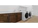This laundry room features a built in counter, laundry sink, and a new washer and dryer at 37727 W Padilla St, Maricopa, AZ 85138