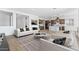 Stylish living room that opens to the kitchen with stainless steel appliances at 37727 W Padilla St, Maricopa, AZ 85138