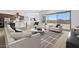 Open living room with modern furniture, hardwood floors, and natural light at 37727 W Padilla St, Maricopa, AZ 85138