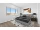 This is the main bedroom which features an area rug, contemporary decor, and a bright window at 37727 W Padilla St, Maricopa, AZ 85138