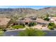 Stunning aerial view of home, showcasing its tile roof, desert landscape, and mountain views at 402 E Windmere Dr, Phoenix, AZ 85048