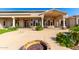 Expansive backyard patio with fire pit, water feature, and multiple seating areas for relaxing or entertaining guests at 402 E Windmere Dr, Phoenix, AZ 85048