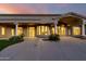 Twilight view of backyard, showing patio, driveway, and a nicely landscaped yard at 402 E Windmere Dr, Phoenix, AZ 85048