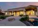 Expansive backyard features desert landscaping, a stone fire pit, and access to a luxurious pool and spa area at 402 E Windmere Dr, Phoenix, AZ 85048