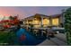 Lush backyard showcasing the pool, rock features, and patio on a sprawling desert estate at 402 E Windmere Dr, Phoenix, AZ 85048