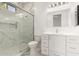 Bathroom featuring a glass shower with marble tile and a white vanity at 402 E Windmere Dr, Phoenix, AZ 85048