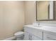 Modern bathroom with a white vanity and a decorative mirror at 402 E Windmere Dr, Phoenix, AZ 85048