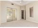 Neutral bedroom with carpet, ceiling fan, mirrored closet and view to the outside at 402 E Windmere Dr, Phoenix, AZ 85048