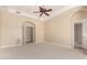 Large, carpeted bedroom with ceiling fan, recessed lighting, and easy access to an ensuite bathroom at 402 E Windmere Dr, Phoenix, AZ 85048