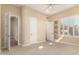 Bright bedroom featuring neutral carpet, ceiling fan, and ample natural light from the shuttered windows at 402 E Windmere Dr, Phoenix, AZ 85048