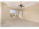 This bedroom offers carpet flooring, ceiling fan, recessed lighting, and an attractive window view at 402 E Windmere Dr, Phoenix, AZ 85048