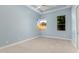Bright blue bedroom offers carpet flooring and natural lighting from the two windows at 402 E Windmere Dr, Phoenix, AZ 85048