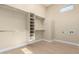Walk-in closet featuring built-in shelving and clothing racks with light hardwood floors at 402 E Windmere Dr, Phoenix, AZ 85048