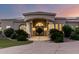 Grand entrance with a covered porch, stone pillars, solar panels, and an elegant front door at 402 E Windmere Dr, Phoenix, AZ 85048