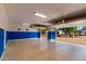 Large three-car garage with epoxy floors and blue trim, leading out to the driveway at 402 E Windmere Dr, Phoenix, AZ 85048