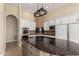 Kitchen featuring a central island with dark countertops and modern stainless appliances at 402 E Windmere Dr, Phoenix, AZ 85048