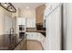 Close-up of a well-lit kitchen with stainless steel appliances and an island with a sink at 402 E Windmere Dr, Phoenix, AZ 85048