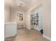Functional laundry room with a utility sink, window, and built-in shelving at 402 E Windmere Dr, Phoenix, AZ 85048