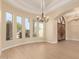 Bright living room featuring recessed lighting, arched windows, and a chandelier at 402 E Windmere Dr, Phoenix, AZ 85048