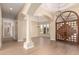 Elegant living room featuring wood floors, an arched doorway, and large windows at 402 E Windmere Dr, Phoenix, AZ 85048