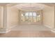 Bright living area featuring large windows showcasing mountain views, with modern ceiling fan and plush carpeting at 402 E Windmere Dr, Phoenix, AZ 85048