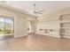 Bright living room featuring a ceiling fan, hardwood floors, sliding glass doors and a modern built-in at 402 E Windmere Dr, Phoenix, AZ 85048