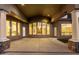 Covered patio with pillars, recessed lighting, stone accents, and expansive views of the backyard and pool area at 402 E Windmere Dr, Phoenix, AZ 85048