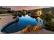 A luxurious backyard features a custom pool with integrated spa, rock waterfall, and desert landscaping at 402 E Windmere Dr, Phoenix, AZ 85048