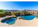 Sparkling pool with integrated spa, rock features, and desert views make this an entertainer's dream at 402 E Windmere Dr, Phoenix, AZ 85048