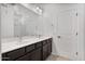 Bathroom with a double sink vanity, large mirror and white door at 4125 W Gary Way, Laveen, AZ 85339