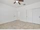 Bedroom featuring tile flooring, a ceiling fan, and a double door closet at 4125 W Gary Way, Laveen, AZ 85339
