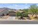 Charming single-story home featuring a neutral color palette, desert landscaping, and a two car garage at 4125 W Gary Way, Laveen, AZ 85339
