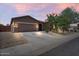 Charming single-story home featuring a neutral color palette, desert landscaping, and a two car garage at 4125 W Gary Way, Laveen, AZ 85339