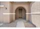 Inviting front entrance showcasing an arched entryway and a modern door at 4125 W Gary Way, Laveen, AZ 85339