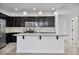 Bright kitchen boasts a central island with sink and eating bar, granite counters, and stainless appliances at 4125 W Gary Way, Laveen, AZ 85339