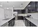 This spacious kitchen features granite countertops, stainless steel appliances, and ample dark wood cabinetry at 4125 W Gary Way, Laveen, AZ 85339