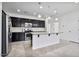 Well-lit kitchen features a spacious island and breakfast bar, stainless steel appliances, and ample counter space at 4125 W Gary Way, Laveen, AZ 85339